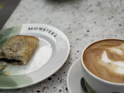 Empanada y capuccino con latte art